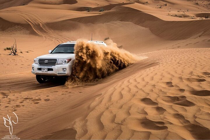 Embrace the excitement of Dubai's desert as you navigate expansive sand dunes feeling the rush of the ride while surrounded by stunning landscapes and endless golden sands.